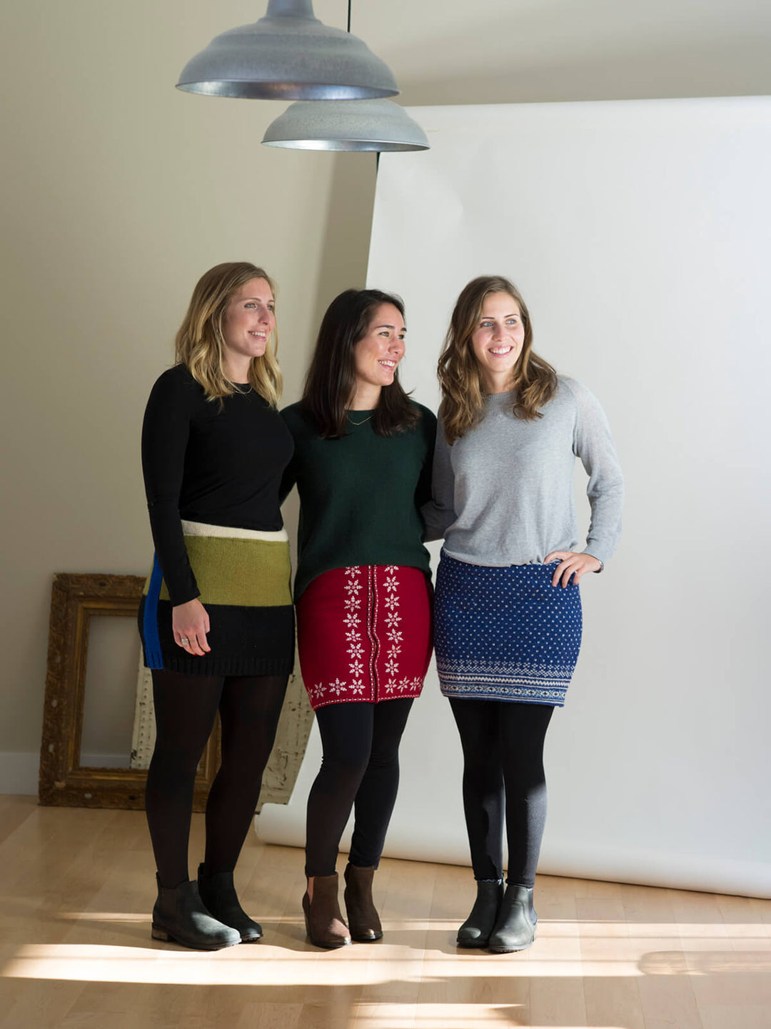 Three models posing in Jack & Mary Designs products