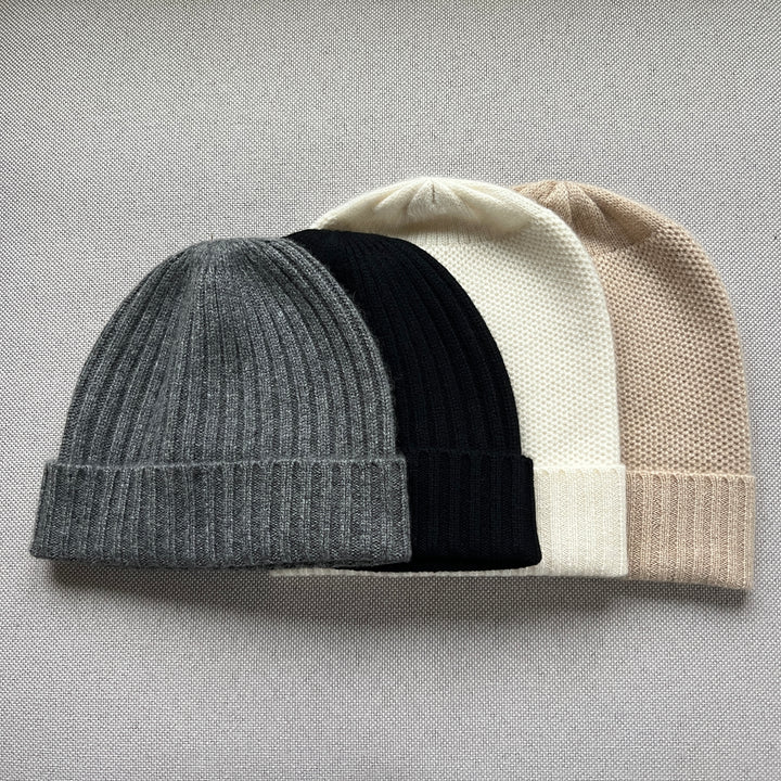 Four cashmere beanies with a ribed cuff. Colors, Charcoal, Black, Cream & acorn. 